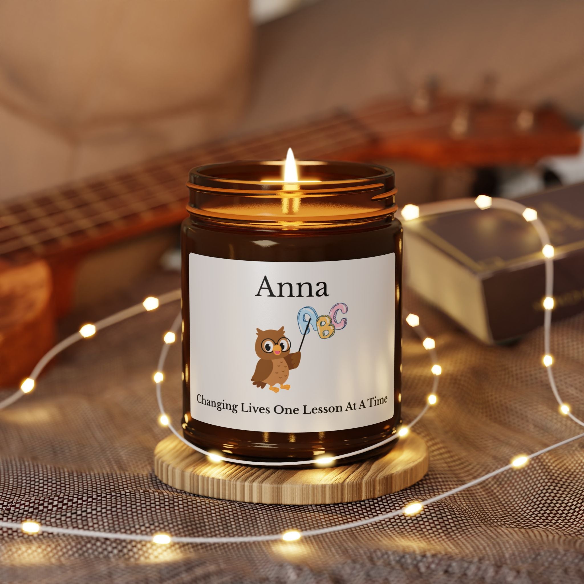Close-up of the owl and alphabet illustration on the candle label