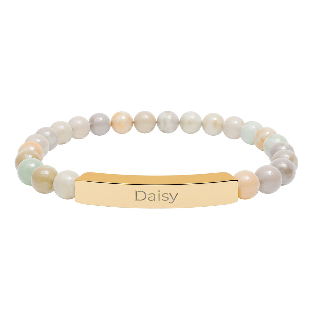 Daisy name bracelet displayed on a flat surface with beads visible