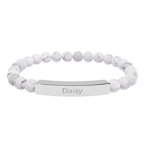 Daisy name bracelet worn on a wrist