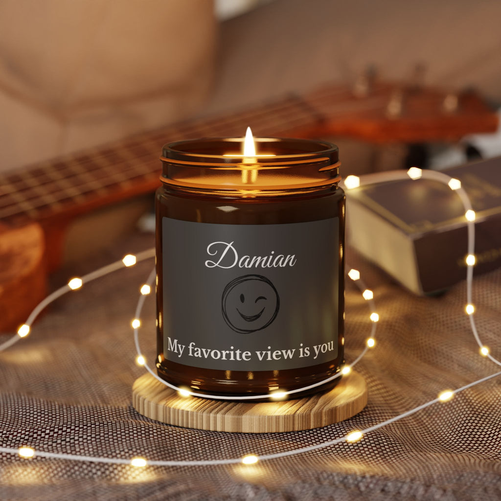 Close-up of charcoal candle label with winking emoji and personalised name in script