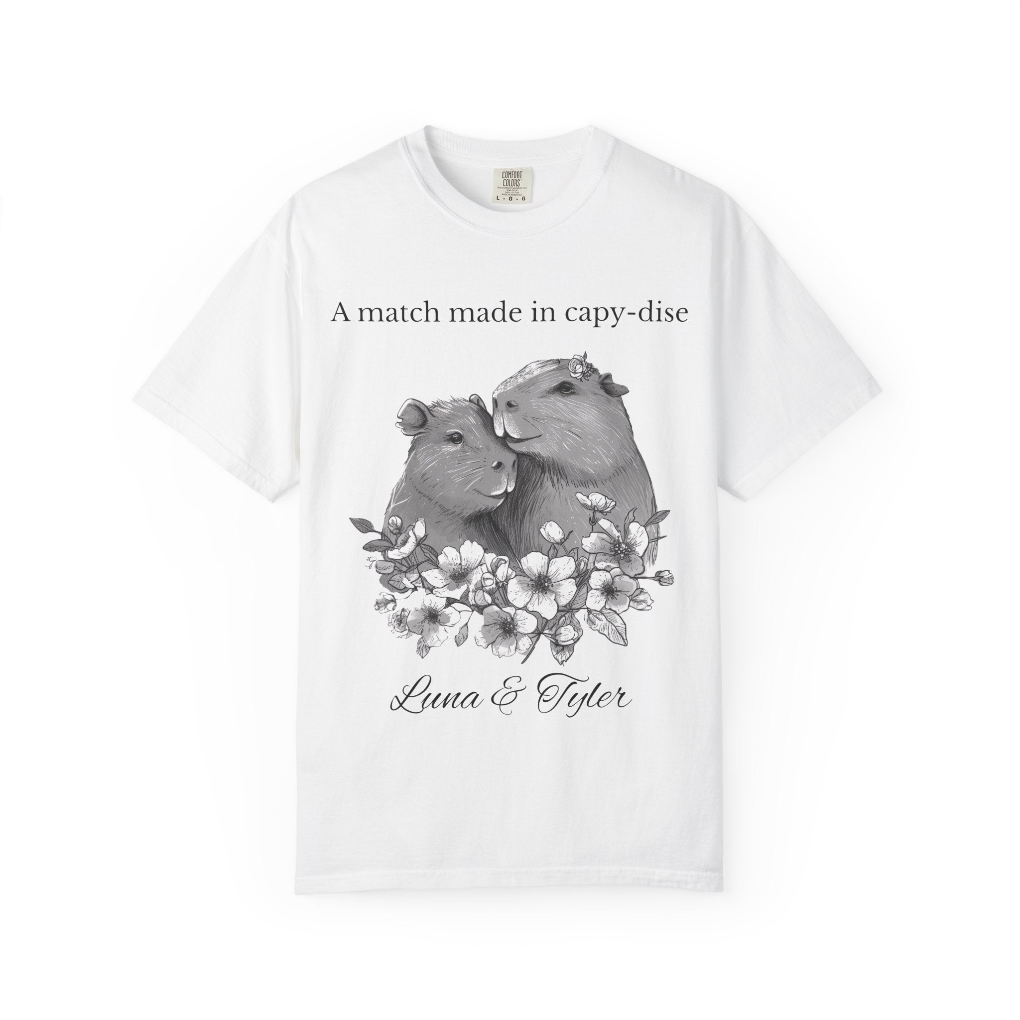 Close-up of cuddled capybara couple and floral artwork on t-shirt