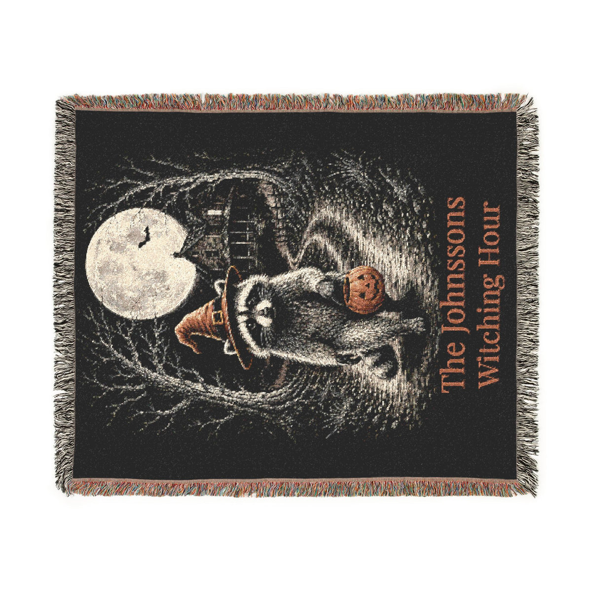 Witching Hour raccoon woven throw blanket shown draped on couch