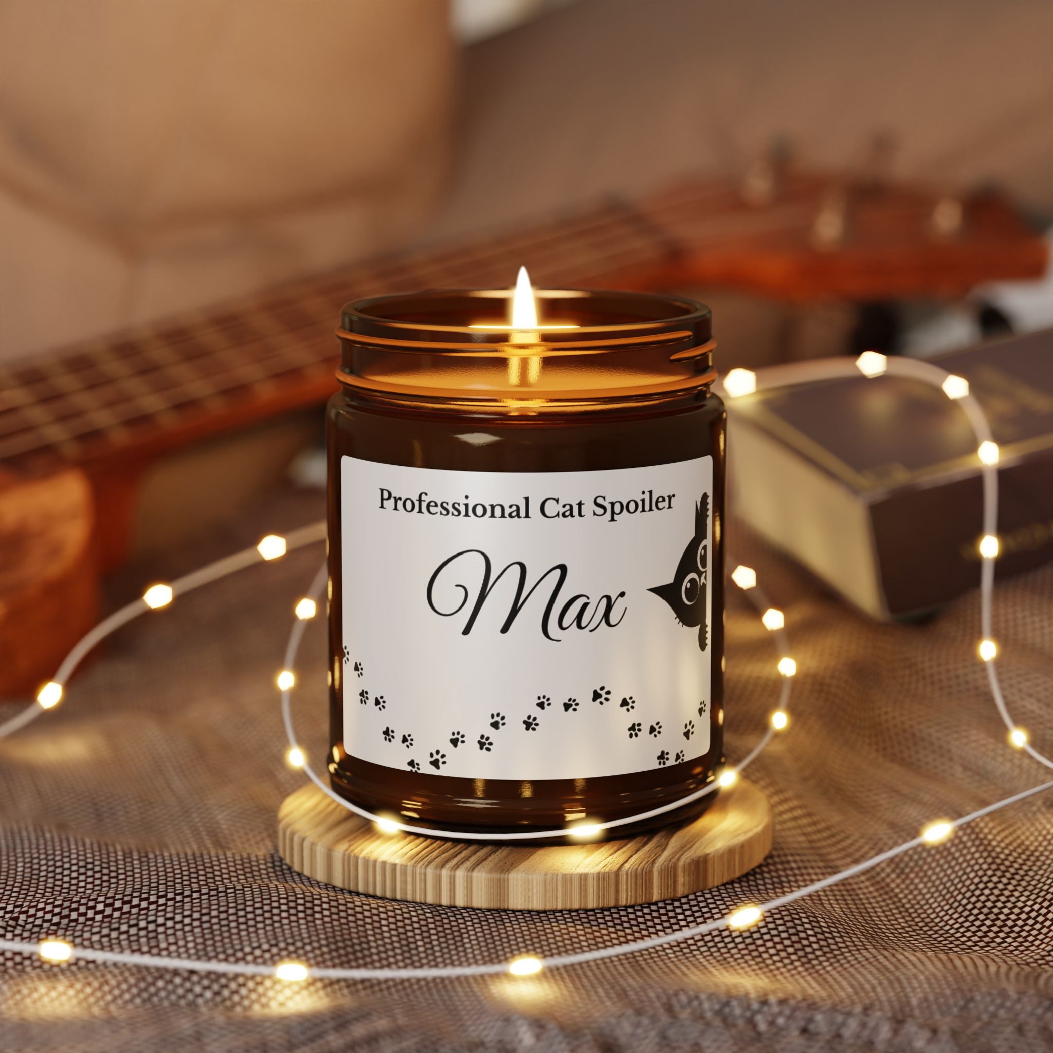 Close-up of the peeking cat illustration and personalised name on the candle label