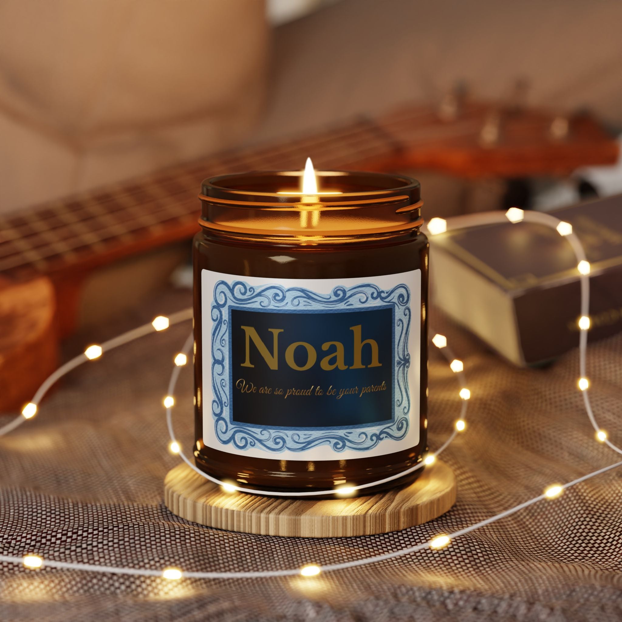 Close-up of ornate blue and gold candle label with swirl border and personalised name
