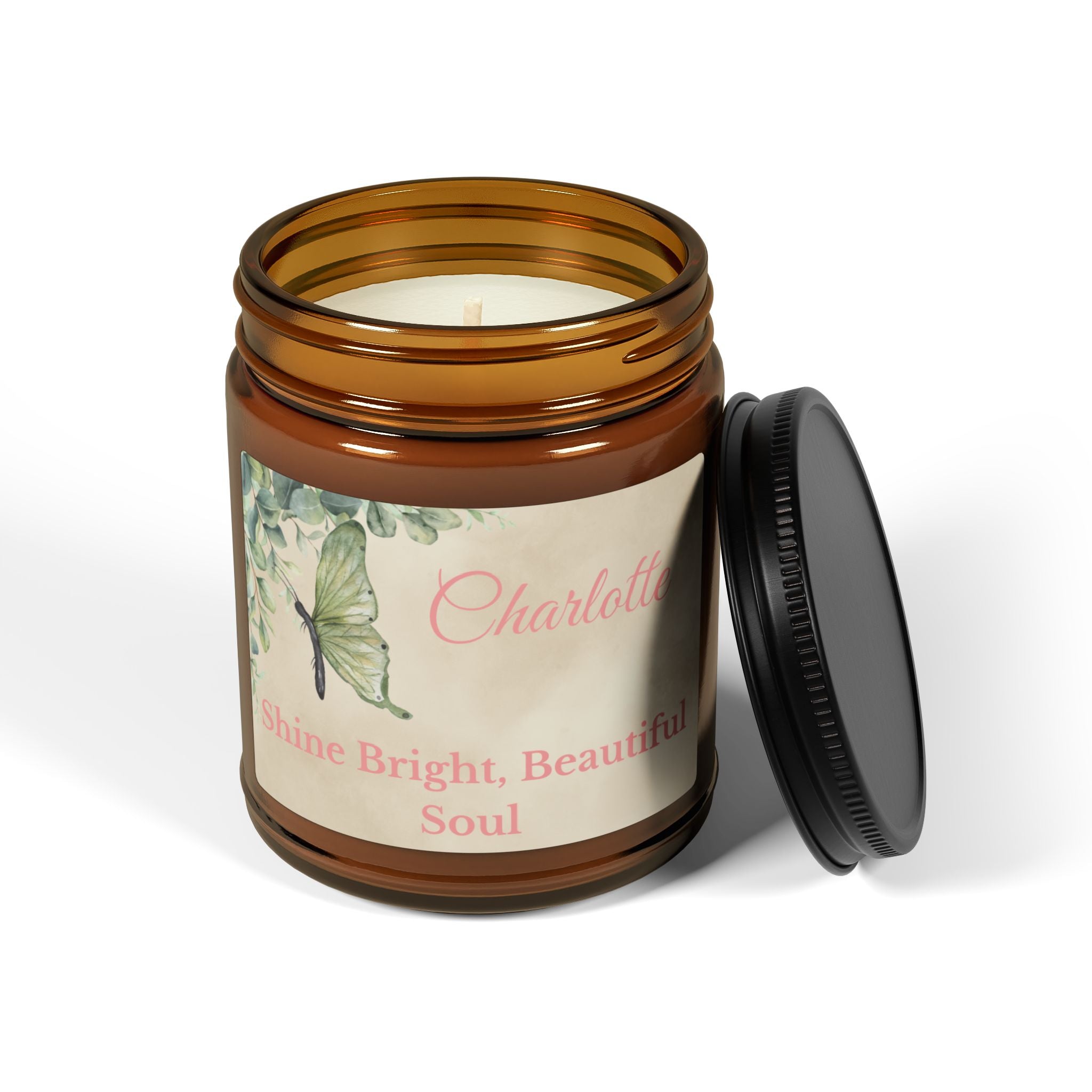 Close-up of botanical candle label with green butterfly, eucalyptus and personalised name