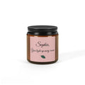 Close-up of personalised candle label with script name and botanical leaf motif